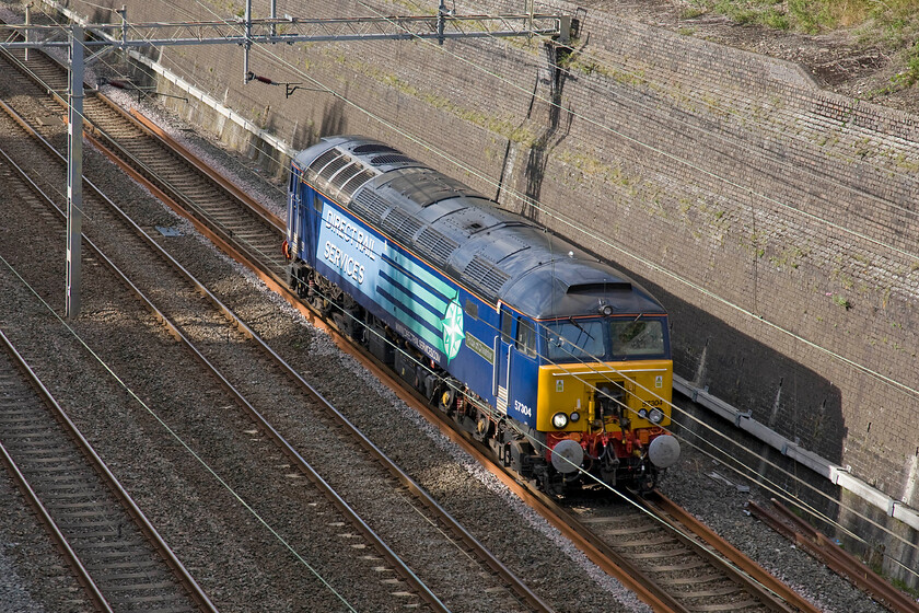 57304, up LE (ex Rugby), Roade cutting 
 DRS' 57304 'Pride of Cheshire' runs light engine through Roade cutting heading south. The locomotive was running from Rugby to Euston as part of the regular shift around of the Thunderbirds. It's a testament to the original Brush design that this 1965 built locomotive is still in operation on the network ready to rescue Virgin Trains that are in trouble at the drop of a hat! 
 Keywords: 57304 light engine Rugby Roade cutting Pride of Cheshire