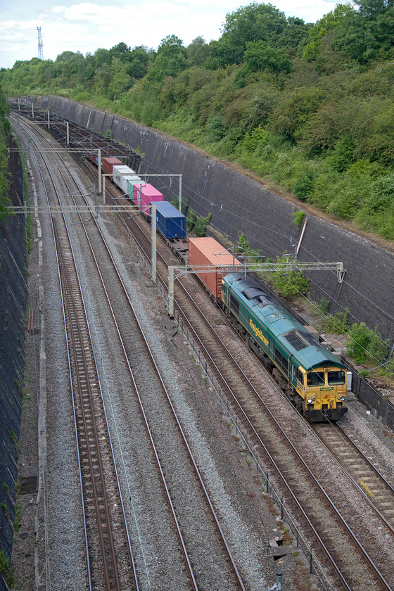 66553, 12.16 Lawley Street-London Gateway (4L46, 3E), Roade cutting 
 After a superb May with record-breaking hours of sunshine, June has started with more cloud! 66553 leads the 12.16 Lawley Street to London Gateway Freightliner through Roade cutting. Rather than the more usual location slightly further south I have gone to the much quieter Thorpe Wood bridge that is much closer to 'The Birdcage' that spans the slow lines that can be seen in this photograph. 
 Keywords: 66553 12.16 Lawley Street-London Gateway 4L46 Roade cutting Freightliner