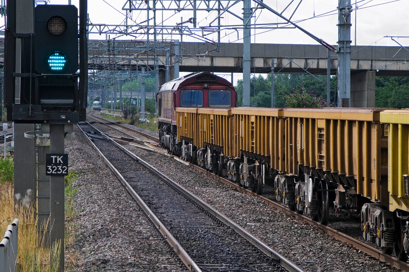 66056, unidentified Wembley Yard-Bescot infrastructure working (7R03), Milton Keynes station 
 66056 waits patiently at the rear of the 7R03 Wembley Yard to Bescot engineering train. It will get underway when there is a gap in down services being forced to take the 'Old' line via Weedon due to an engineering pocsession on the Northampton line. This image is looking south from the extreme southern end of Milton Keynes station. 
 Keywords: 66056 Wembley Yard-Bescot infrastructure working 7R03 Milton Keynes station.jpg