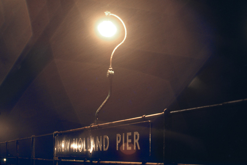 LNER Globe & enamel, New Holland pier 
 In blizzard conditions on New Holland pier, one of the many LNER globe lamps that lined the pier is seen with a huge enamel sign underneath. When I visited the pier last in 2007 the lamps had been removed, I wonder where these elegant pieces of infrastructure ended up; not just sold for scrap I hope? I also managed to photograph another example a few months later at March, see....https://www.ontheupfast.com/p/21936chg/30044135659/x22-lner-globe-lamp-footbridge-march but this was a to slightly different design. 
 Keywords: LNER Globe enamel New Holland pier