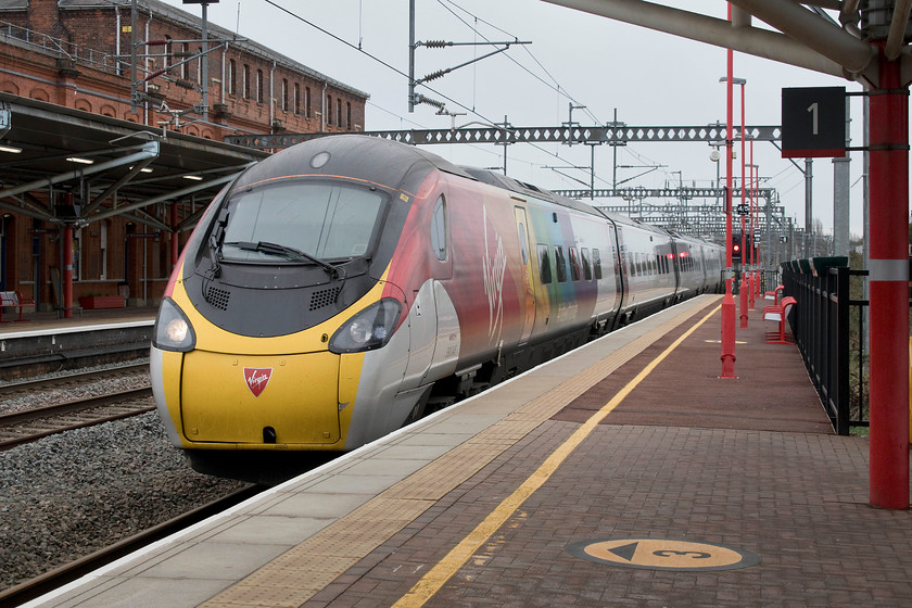 390045, VT 11.03 London Euston-Birmingham New Street (9G16, 5L), Rugby station 
 The first of our 'off piste' trains that had to be taken so that we could get to Leeds. Here, 390045 ' Virgin Pride' arrives into Rugby with the 11.03 Euston to Birmingham New Street. This train was taken to New Street in order for us to get a much later Cross Country service that we would have done from Tamworth if our intended connecting train had not gone without us. 
 Keywords: 390045 11.03 London Euston-Birmingham New Street 9G16 Rugby station