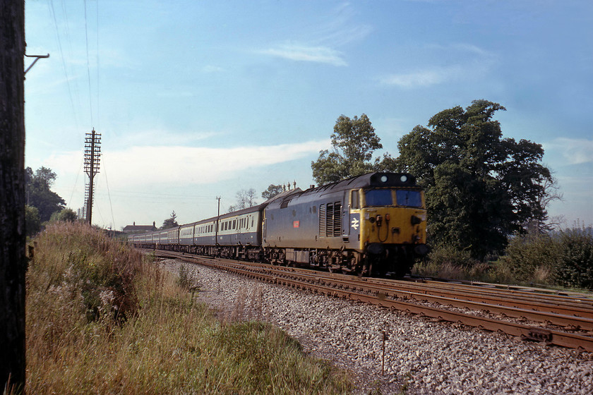 50015, 10.05 Paignton-London Paddington (1A43), Blatchbidge Junction 
 Taken from a foot crossing at Blatchbridge Junction located to the south of Frome where the cut-off and Frome station lines come together again. 50015 'Valiant' passes the signal box, the roof of which can be seen above the locomotive, leading the 10.05 Paignton to Paddington express. By an incredible coincidence, I visited this same spot thirty-six years later in 2015 on exactly the same day and photographed the 11.30 Paignton to Paddington HST at an almost identical angle, see.... https://www.ontheupfast.com/p/21936chg/29207532004/x43093-11-30-paignton-london-paddington 
 Keywords: 50015, 10.05 Paignton-London Paddington (1A43), Blatchbidge Junction