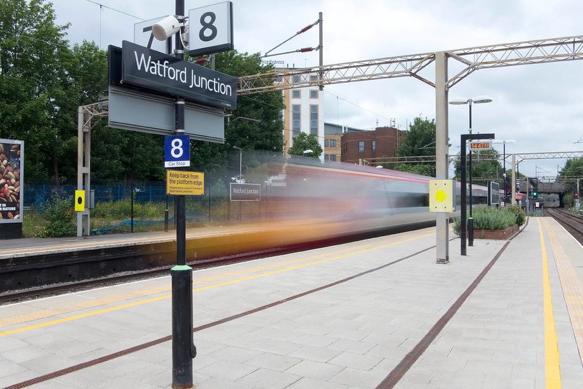 Class 390, VT 12.55 Manchester Picadilly-London Euston, Watford Junction station 
 We had to change trains at Watford Junction on our return journey to Milton Keynes. Whilst standing on platform eight I managed to photograph a class 390 racing through the station working the 12.55 Manchester Piccadilly to Euston. I opted for a slow shutter speed (1/5 sec.) as it was too dull to use a fast shutter speed without introducing too much digital noise. I think that result is quite interesting. It's also notable that even when it is this blurred, the train is instantly recognisable as a Pendolino. 
 Keywords: Class 390 12.55 Manchester Picadilly-London Euston Watford Junction station