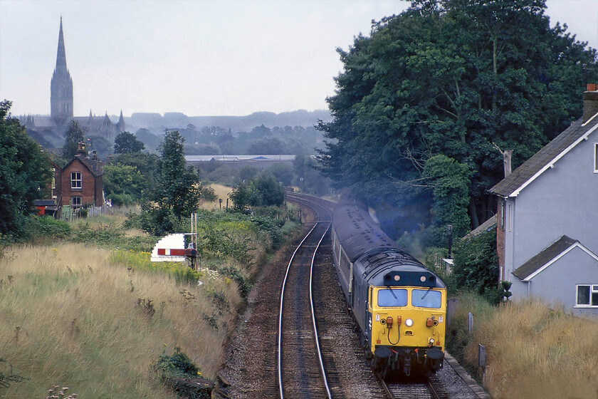 50017, 15.10 London Waterloo-Exeter St. David's (1V15), Skew bridge Bemerton 
 Working hard as it climbs away from Salisbury 50017 'Royal Oak' leads the 1V15 15.10 Waterloo to Exeter St. David's service. With these services having been in the hands of many different classes over the years the Class 50s were proving to be reliable and competent on these services augmented by some Class 47s. These trains would be for many members of the class their final as withdrawl started in the late 1980s and early 1990s. Notice the maginificant spire of Salisbury catherdral dominationg the skyline to the right. 
 Keywords: 50017 15.10 London Waterloo-Exeter St. David's Skew bridge Bemerton Royal Oak