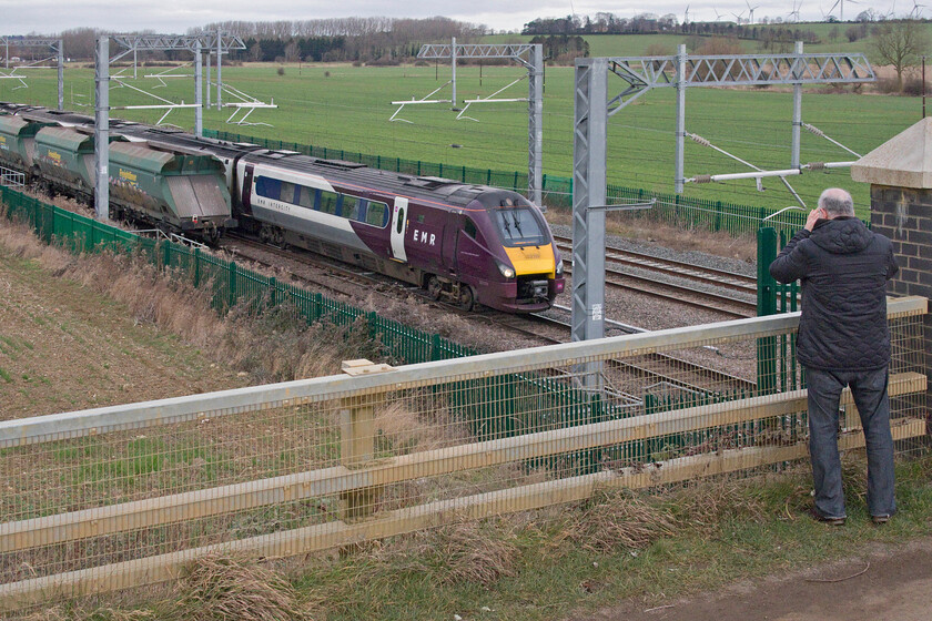 Andy, 15.52 Radlett Redland-East Usk Yard (6V54, 21E) & 222102, EM 13.00 Sheffield-London St. Pancras (1C53, 2L), Harrowden Junction 
 Andy captures the action at Harrowden Junction on his trusty but rather ancient, by digital camera standards at least, Canon D60! I hope that he was pleased with his twin-train shot showing EMR's 222102 approaching Wellingborough working the 13.00 Sheffield to St. Pancras service with the tail end of the 6V54 'Redlands' (the 6V54 15.52 Radlett to East Usk) just going out of view. These were our last two trains of our short trip on this grey February day before we headed home; here's to some more days out this year! 
 Keywords: Andy 15.52 Radlett Redland-East Usk Yard 6V54 222102 13.00 Sheffield-London St. Pancras 1C53 Harrowden Junction EMR East Midlands Railway Meridian