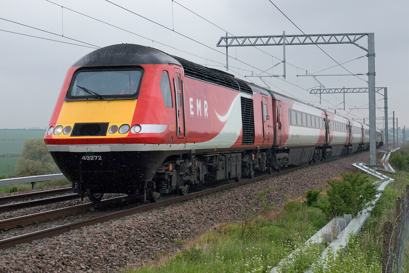 43272, EM 06.35 Leeds-London St. Pancras (1B23, 3E), Wymington SP946644 
 The penultimate up HST working......

In pouring rain the 1B23 06.35 Leeds to St. Pancras climbs Sharbrook bank past Wymington with former Virgin East Coast/LNER power car 43272 leading set NL57 with 43309 bringing up the rear. The driver gave me a cheery wave as he passed and a firm blow on the horn. I was surprised that I was the only enthusiast at this open spot that was close to a number of public footpaths but it did require a fair trek from my parked van donning my GoreTex waterproof and boots! 
 Keywords: 43272 06.35 Leeds-London St. Pancras 1B23 Wymington SP946644 EMR HST East Midlands Railway