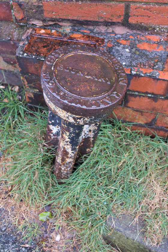 GWR boundary post, Criccieth SH49683806 
 GWR boundary posts pop up all over the place and, if you walk with your head down, they can be found marking the boundary of GWR property where there is no obvious feature to indicate it. Here in Criccieth, a short distance from the station, this one remains on the entrance road. 
 Keywords: GWR boundary post Criccieth