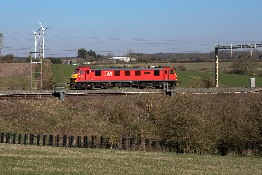 90019, 13.35 Crewe TMD-Wembley yard (0A06, 50E), Roade Hill 
 I was led to believe that this was to have been one of Grand Central's freshly painted Class 90s returning to Wembley after testing. However, being a red DB version I am not sure this was correct gen! However, 90019 'Multimodal' certainly looks better amongst the early spring greenery than would have one of GC's in black! The light engine left Crewe at 13.35 running to Wembley Yard as 0A06 and is seen from Roade Hill just south of the village of the same name. 
 Keywords: 90019 13.35 Crewe TMD-Wembley yard 0A06 Roade Hill Light Engine LE Multimodal