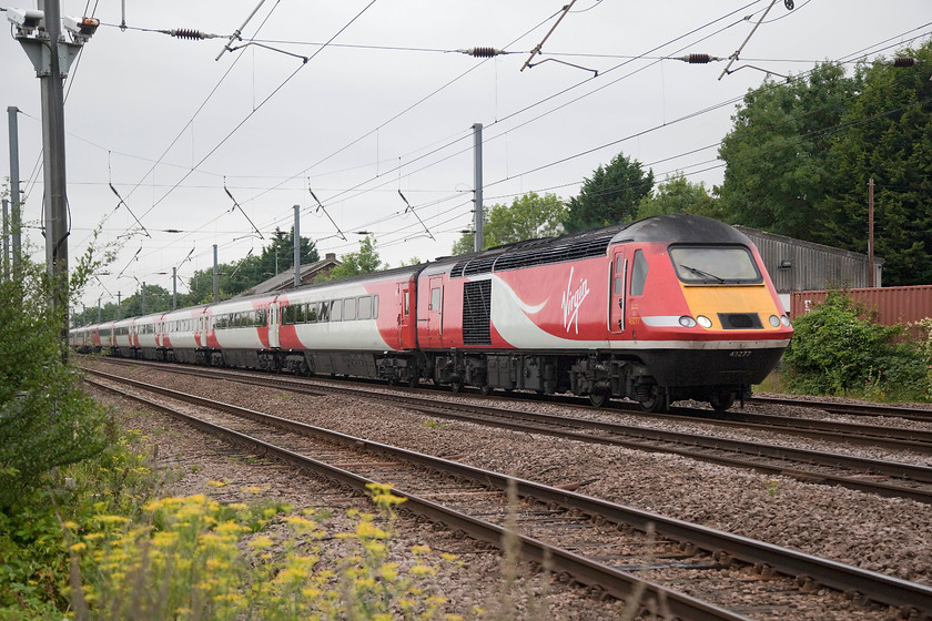 43277, GR 09.08 London Kings Cross-Leeds (1N81, RT) 
 43277 leads the 09.08 King's Cross to Leeds past Tempsford level crossing. 43277 was originally numbered as 43077 and started its working life on this line in 1978 as part of set 254011. Thirty-nine years later, here it is thrashing up and down doing exactly what it was designed to do. 
 Keywords: 43277 1N81 Tempsford Crossing