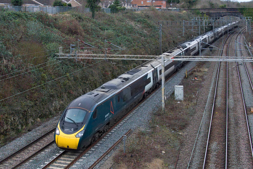 390137, VT 11.18 Preston-London Euston (9A52, RT), A508 bridge 
 390137 passes through Roade about to pass under the former A508 bridge working the 11.18 Preston to Euston service. It is much easier to photograph trains from this side of Bridge 207 due to there being no walkway on the other side and a very high parapet. However, with the opening of Roade bypass the other side is a safer proposition. 
 Keywords: 390137 11.18 Preston-London Euston 9A52 A508 bridge AWC Avanti West Coast Pendolino