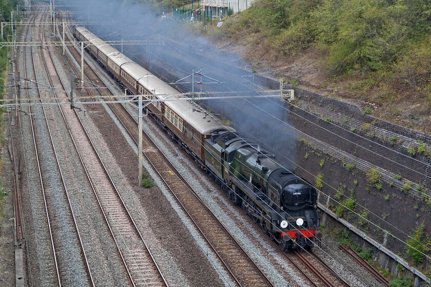 34046, 09.05 Crewe HS-Southall LSL (5Z47, 18L), Roade cutting 
 Unusually, for an empty stock move, West Country 34046 'Braunton' was operating on its own without any assistance from the trailing diesel. It is seen working hard through Roade cutting hauling the 09.05 Crewe HS to Southall LSL with D1935 (47805) Roger Hosking MA 1925-2013 at the rear. Notice that the SR locomotive is carrying the correct headcode indicating a class three (empty stock working) but that the train was given the reporting number of 5Z47 as is more common for such a train today. 
 Keywords: 34046 09.05 Crewe HS-Southall LSL 5Z47 Roade cutting Braunton