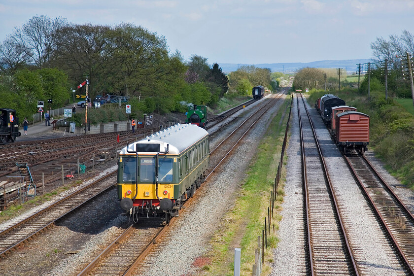 121034, CH 16.05 Quainton Road-Aylesbury (1T91), Quainton Road footbridge 
 Sometimes, the sun does come just right! With Chiltern's 121034 heading away from Quaiton Road for the short trip to Aylesbury the background is in shadow with the Bubbe Car nicely illuminated by the afternoon spring sunshine. The DMU is on what is in fact Network Rail metals with all the other lines visible being operated by The Buckinghamshire Railway Centre. The track it is running on extends northwestward behind me through Quainton Road station following the route of the former Great Central line to Claydon Junction where it joins with the east-west former Varsity Line. The track is used almost exclusively by trains taking spoil to the former quarries at Calvert and perhaps the odd and very rare charter. 
 Keywords: 121034 16.05 Quainton Road-Aylesbury 1T91 Quainton Road footbridge Chiltern Bubble Car DMU