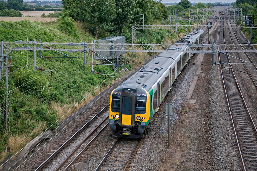 350258, unidentified down working, Victoria bridge 
 An unidentified London Midland service heads north past Victoria bridge between Roade and Ashton worked by 350258. A Virgin Pendolino can just be seen heading south away from the camera on the up fast line. 
 Keywords: 350258 unidentified down working Victoria bridge London Midland Desiro