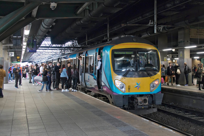 185107, TP 13.55 Middlesborough-Manchester Airport (1P78, 6L), Manchester Victoria station 
 This picture illustrates why I do not like Manchester Victoria station a great deal. It's a dark and oppressive subterranean station being built underneath the huge Manchester Arena complex, the scene of the 2017 Ariana Grande concert bombing. In this busy view taken during the evening commuter period, 158107 is already running late as it pauses with the 13.55 Middlesborough to Manchester Airport service. There was much frenetic blowing of whistles in order to get the train boarded as quickly as possible, something that I dislike intensely and one that makes me deliberately slow down and take my time trying to be the last to causally board the train. Now, where's my application form for the 'awkward squad' gone! 
 Keywords: 185107 13.55 Middlesborough-Manchester Airport (1P78, 6L), Manchester Victoria station