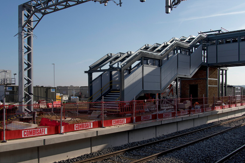 Former platform 5 & new footbridge, Wellingborough station 
 The extension to Wellingborough's footbridge is now fairly advanced with the steps now in place. Last time I visited, the lift tower framework had just been constructed, see.... https://www.ontheupfast.com/v/photos/21936chg/28348129804/x222023-14-12-nottingham-london-st Not only will there be access to the new platform four from the new bridge but also from beyond the platform where a huge new car park is planned. 
 Keywords: Former platform 5 new footbridge Wellingborough station