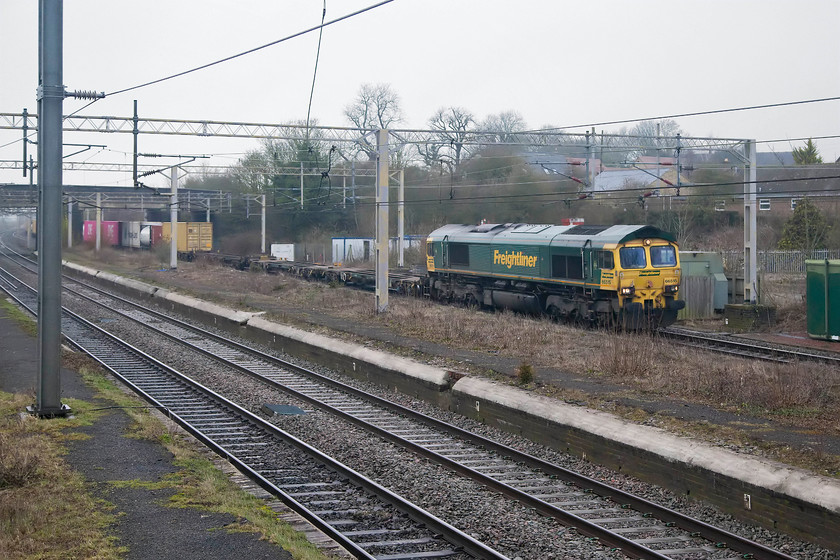 66515, 03.25 Garston FLT-London Gateway (4L52), site of Castelthorpe station 
 The 03.26 Garston Freightliner terminal to London Gateway is hauled past the site of Castlethorpe station by 66515. The station platforms ar still very much intact and are only a short jump down from where I am taking the picture....it's so tempting but I never would off course! 
 Keywords: 66515 03.25 Garston FLT-London Gateway 4L52 site of Castelthorpe station