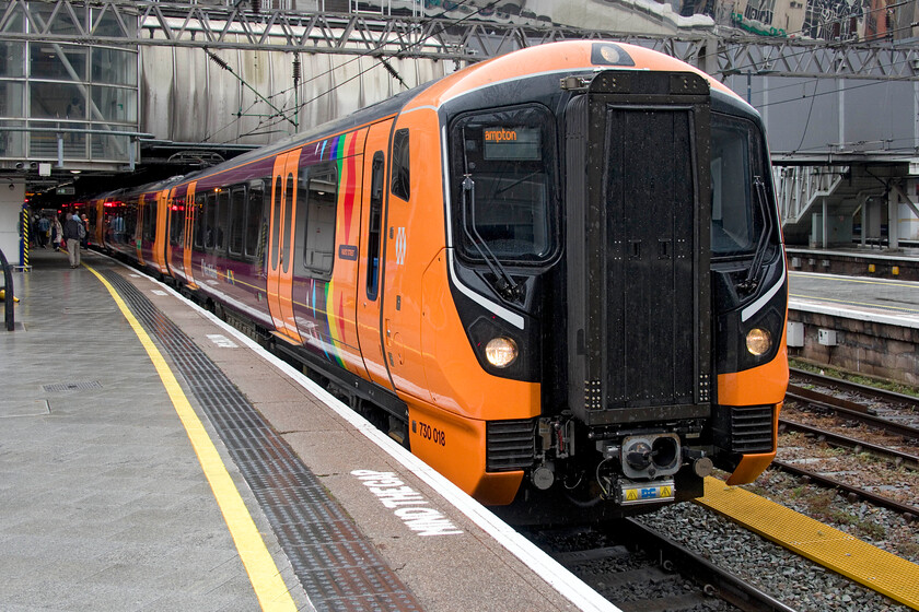 730018, LN 10.07 Walsall-Wolverhampton (2W18, RT), Birmingham New Street station 
 Aventra 730018 pauses at Birmingham New Street having just arrived with the 10.07 Walsall to Wolverhampton service. I had just travelled on this train in from Bescot Stadium station. This marked my first time travelling on board one of these units, finding it to be pleasant enough (hard seats aside) with strong lighting and noting how quiet it was. It's a shame that the uncontrolled lineside growth on the route was dragging along the side of the train doing nothing for the smart new paintwork! 
 Keywords: 730018 10.07 Walsall-Wolverhampton 2W18 Birmingham New Street station London Northwestern Aventra