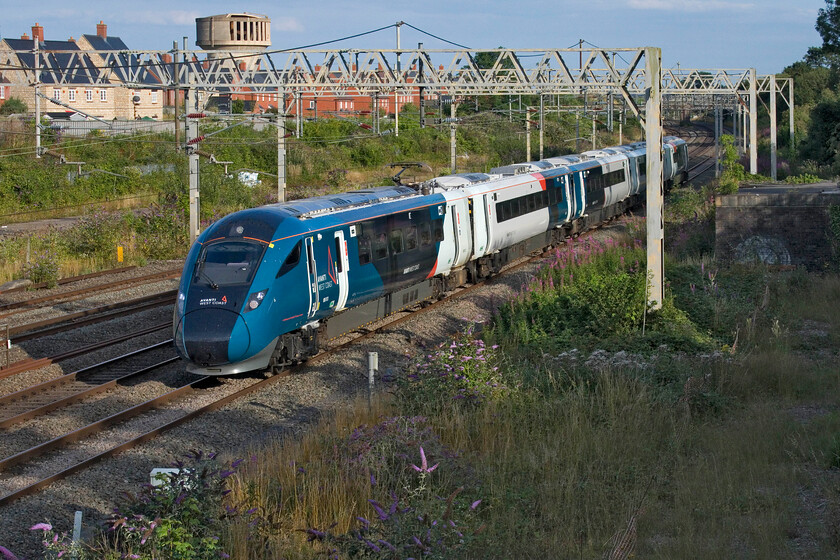 805013, VT 18.01 London Euston-Holyhead (1D92, 13L), site of Roade station 
 The new face (and sound) of the West Coast Mainline in the form of an Evero passes Roade on a superb Sunday evening. 805013 is seen working the 18.01 Euston to Holyhead service. I suspect that the regular passengers will have welcomed the move to the new trains compared with the tired and worn-out Voyagers; good luck to CrossCountry who have taken some of them on! 
 Keywords: 805013 18.01 London Euston-Holyhead 1D92 site of Roade station Avnti West Coast Evero