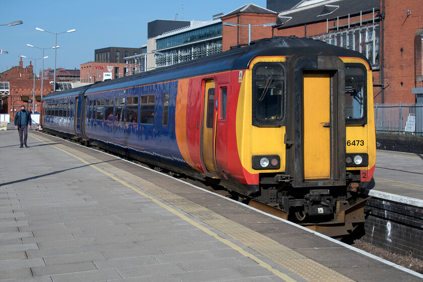 156473, EM 09.56 Nottingham-Skegness (2S11, 2E), Nottingham station 
 156473 basks in the early spring sunshine at Nottingham station. It will soon work the 09.56 service to Skegness but being still in the midst of the COVID pandemic I wonder how many holidaymakers or day-trippers will be making this fabled trip to the east coast? 
 Keywords: 156473 09.56 Nottingham-Skegness 2S11 Nottingham station EMR East Midlands Railway