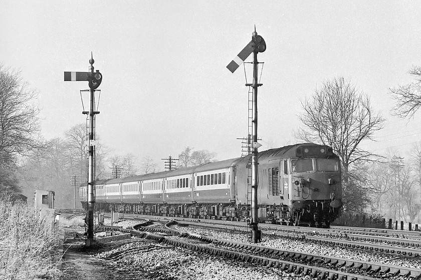 50026, 08.35 Penzance-London Paddington, Woodborough SU097595 
 50026 'Indomitable' approaches Woodborough in Wiltshire about to pass its down home signals. It is heading the 08.35 Penzance to London Paddington. This is a fairly short train composed of five Mk. IIF coaches, an earlier non-air conditioned Mk. II coach and hanging on at the rear, a Mk. I BG. 'Indomitable' is still with us owned by Paul Spracklen and based on the Severn Valley Railway. It is in Network South East livery and is being prepared for a return to the mainline, currently all the mainline required paraphernalia is being fitted at huge expense. 
 Keywords: 50026 08.35 Penzance-London Paddington Woodborough SU097595