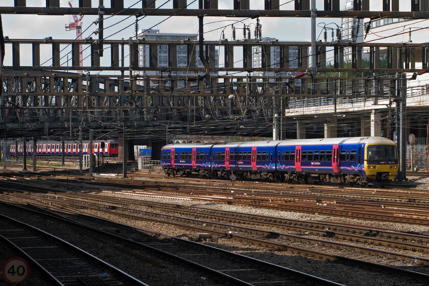 165108, GW 11.38 Bedwyn-London Paddington & unidentified C Stock working, London Paddington station 
 The northern side of Paddington's throat is interesting as the TfL lines run parallel to the heavyweight tracks for some distance just beyond Royal Oak. A photograph that illustrates this shows 165108 approaching Paddington working the 11.38 from Bedwyn whilst a C stock TfL service heads off I presume operating either a Circle or Hammersmith & City Line service to Hammersmith. 
 Keywords: 165108 11.38 Bedwyn-London Paddington & unidentified C Stock working London Paddington station Thames Turbo FGW First Great Western