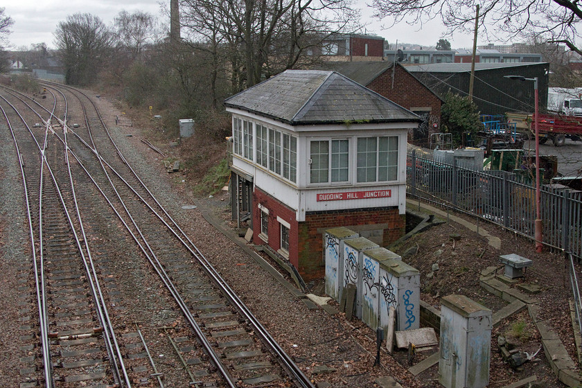 Dudding Hill Junction signal box (Midland, C.1902) TQ227858 
 Remarkable survivor number 3.....

Taken from a pedestrian bridge in Dollis Hill's Gladstone Park the well preserved Dudding Hill Junction signal box is seen. It is a Midland structure dating from c.1902 that has undergone some modernisation with cladding and new windows. From this angle, its rather ugly extension is not so visible but at least it has a nice red Midland style name board. It controls the splitting junction that permits access to the Midland mainline, to the north (left in this image) into Brent Yard and the south to Cricklewood. I took a very similar photograph during my visit with Graham in November 1979, see...... https://www.ontheupfast.com/v/photos/21936chg/27444281004/dudding-hill-junction-signal-box 
 Keywords: Dudding Hill Junction signal box Mid C.1902 TQ227858