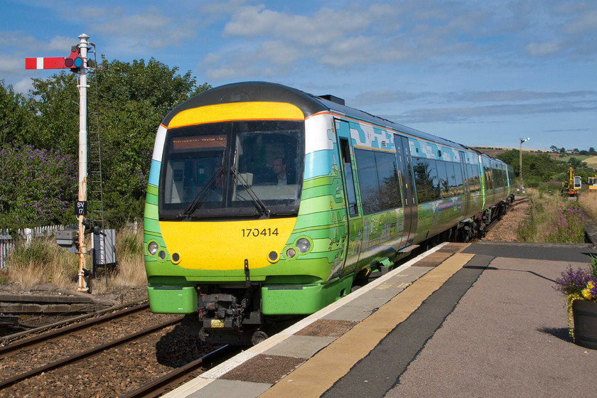 170414, SR 14.04 Aberdeen-Edinburgh Waverley (1B35), Stonehaven station 
 170414 was seen a little earlier in the day at Dyce station working to Inverurie, see.... https://www.ontheupfast.com/p/21936chg/28943042804/x170414-12-50-aberdeen-inverurie and here it is again working the 14.04 Aberdeen to Edinburgh 1B35. It is arriving at Stonehaven station passing SV17, the down starter. This special one-off livery was applied to 170414 to commemorate the imminent re-opening of the Borders Railway as far as Tweedbank. 
 Keywords: 170414 14.04 Aberdeen-Edinburgh Waverley 1B35 Stonehaven station Borders Railway ScotRail