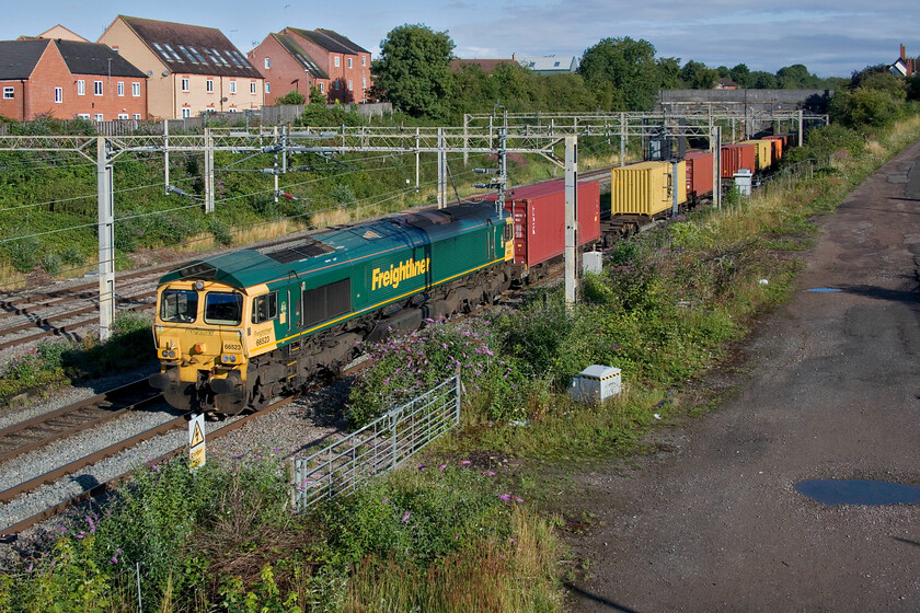 66523, 03.39 Garston-London Gateway (4L52, 2L), site of Roade station 
 66523 bursts into the sunshine at the southern end of Roade cutting leading the 03.39 Garston to London Gateway 4L52 Freightliner service. This is a preferred location for southbound trains at this time of day on a sunny morning but has been made more tricky in the last year by the installation of an anti-climb parapet installed by Network Rail so some short steps are no required. 
 Keywords: 66523 03.39 Garston-London Gateway 4L52 site of Roade station Freightliner