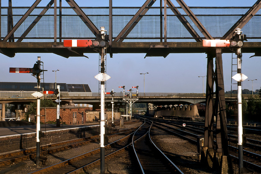 Signalling, Lincoln Central station 
 With no fewer than ten semaphore arms in view, the eastern end of Lincoln station is seen on this pleasant late summer's evening. In the foreground are four up homes all controlled by Pelham Street Junction box that is seen in the distance just under the Pelham Street/Canwick Road viaduct constructed in 1958 to replace yet another congestive level crossing. In the centre distance is the impressive junction bracket. The left-hand doll was for the former Midland and Great Central Market Rasen route to Grimsby whilst the home and distant to the right were for the Sleaford route. The two smaller signals in the centre controlled entry to the depot and yard roads. Whilst then track layout in Lincoln's station throat is similar today all this delightful signalling was wiped away when the Lincoln Signalling Centre opened in 2008. 
 Keywords: Signalling Lincoln Central station semaphores