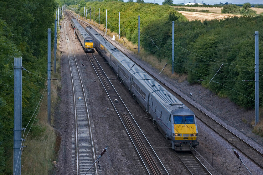 82201, GR 06.50 Glasgow Central-London King's Cross (1E06) & Class 91 GR 10.30 London King's Cross-Edinburgh Waverley (1S12), Westby SK962271 
 A crossing of East Coast services near the summit of Stoke bank near the village of Westby. Whilst the 10.30 King's Cross to Edinburgh is just in some sunshine with an unidentified Class 91 providing the power, the 06.50 Glasgow to London is in the shadows! The latter is being led by DVT 82201 with another unidentified Class 91 at te rear. 
 Keywords: 82201 06.50 Glasgow Central-London King's Cross 1E06 Class 91 10.30 London King's Cross-Edinburgh Waverley 1S12 Westby SK962271 East Coast