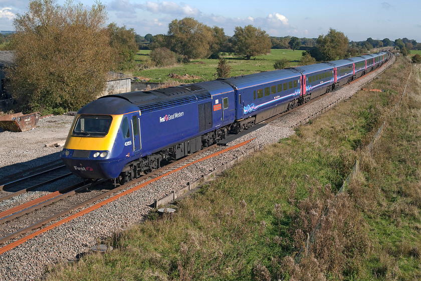 43155, GW 11.15 London Paddington-Swansea (via Gloucester) (1B27), Ashbury Crossing SU246878 
 43155 'The Red Arrows 50 Seasons of Excellence' passes Ashbury Crossing near Shrivenham with the 11.15 Paddington to Swansea that was routed via Gloucester due to engineering works in the Severn Tunnel. Despite the fact that the electrification should be almost complete by now, at this location there is no evidence whatsoever apart from some covered pilings directly in the foreground that will take the masts. This classic view from the relatively new concrete occupation bridge will then change forever and a picture such as this will become impossible. 
 Keywords: 43155 11.15 London Paddington-Swansea via Gloucester 1B27 Ashbury Crossing SU246878