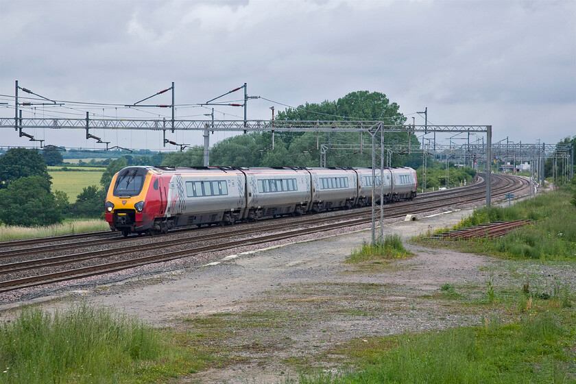 Class 221, VT 06.52 Holyhead-London Euston (1A15), Gordon's Lodge 
 Under dismal skies and unidentified Class 221 passes Gordon's Lodge just north of Hanslope Junction working the 06.52 Holyhead to Euston train. There was once a loop to the right of the lines in this view witnessed by the extra width of the electrification masts. 
 Keywords: Class 221 06.52 Holyhead-London Euston 1A15 Gordon's Lodge Virgin Trains