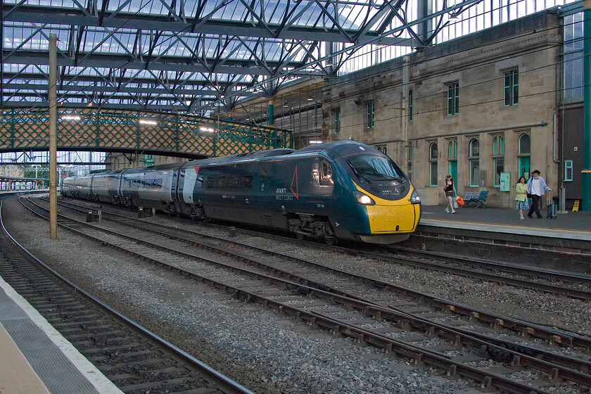 390148, VT 16.39 London Euston-Edinburgh Waverley (9S93, 33L), Carlisle station 
 Running very late, as all services both north and south were, 390148 'Flying Scouseman' drifts into Carlisle station working Avanti's 16.39 Euston to Edinburgh Waverley service. This train did make up a little more time during the last part of its journey arriving a mere thirty-three minutes adrift! 
 Keywords: 390148 16.39 London Euston-Edinburgh Waverley 9S93 Carlisle station AWC AvantiWest Coast Flying Scouseman