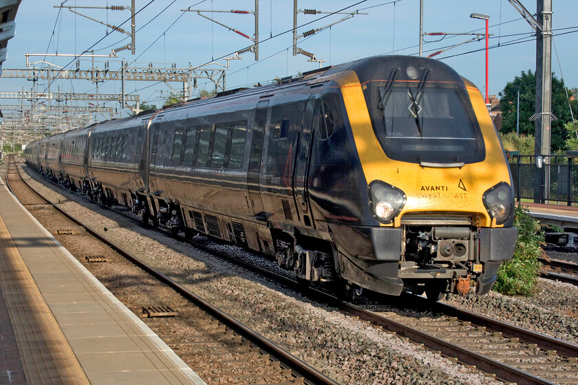 221108 & 221115, VT 18.23 London Euston-Shrewsbury (9J38, 1E), Rugby station 
 The 18.23 Euston to Shrewsbury Avanti Voyager service passes through Rugby at line speed in the evening sun. It is services such as this that will be operated by Avanti's new bi-mode trains that are to be introduced into service next year with these diesel units being retired from WCML duties and not before time!

NB on re-reading this just a week before the start of 2024 I can report that despite testing and mileage accumulation runs that the Class 805s have yet to enter service! 
 Keywords: 221108 221115 18.23 London Euston-Shrewsbury 9J38 Rugby station Avanti West Coast Voyager