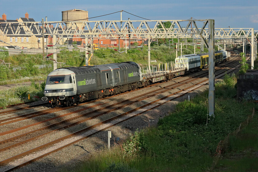 43480, 43468 & Class 777 (777035?), 18.31 Wembley Yard-Walton Old Junction (6Q77, RT), site of Roade station 
 What is supposed to be the final Merseyrail Class 777 new unit move passes Roade in some super evening sunshine; something that has been lacking so far this spring and early summer! I believe that the unit is 777035 but am happy to be corrected if anybody knows better! Railadventure's (sic) 43480 and 43468 are towing the unit with some appropriate barrier coaches to assist with brake force. Delivery of the Class 777s was supposed to have been completed four years ago but, as usual, various teething problems pushed this date back including COVID which seems to be blamed for most things! 
 Keywords: 43480 43468 Class 777 777035 18.31 Wembley Yard-Walton Old Junction 6Q77, RT site of Roade station Railadventure HST