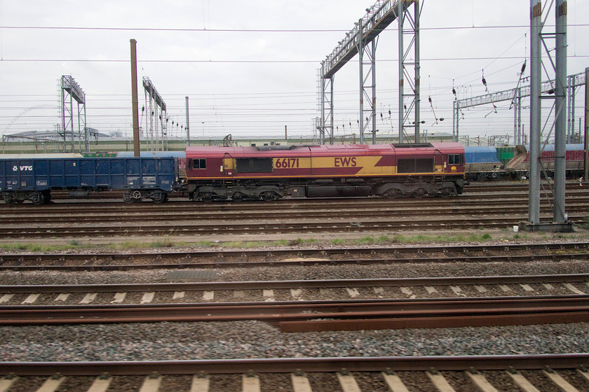 66171, stabled, Wembley Yard 
 By the time we got to London, the sun in Northampton had given way to a grey and overcast afternoon. In Wembley Yard, 66171 sits stabled at the head of some large wagons. 
 Keywords: 66171 stabled, Wembley Yard