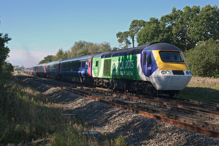 43126, GW 10.30 Bristol Temple Meads-London Paddington (1A15), Ashbury Crossing SU246878 
 Wearing its instantly recognisable and unique vinyls, 43126 leads the 10.30 Bristol Temple Meads to Paddington 1A15 service. It is seen passing the site of Ashbury level crossing that was closed in the early 1970s to be replaced by a huge concrete bridge, allegedly so that the local hut could still cross the railway. 
 Keywords: 43126 10.30 Bristol Temple Meads-London Paddington 1A15 Ashbury Crossing SU246878