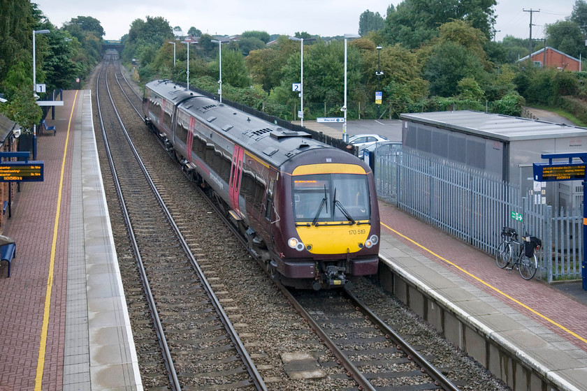 170519, XC 08.21 Stansted Airport-Birmingham New Street (1N47), Narborough station 
 As I was leaving Narborough station after alighting from 170109 the barriers went down again at the level crossing behind where I am standing on the station's footbridge. 170519 passes through the station working the 1N47 08.21 Stansted Airport to Birmingham New Street as my bike leans against palisade fencing to the right. 
 Keywords: 170519 08.21 Stansted Airport-Birmingham New Street 1N47 Narborough station CrossCountry XC