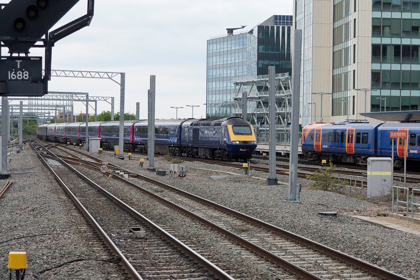 43158, GW 13.05 London Paddington-Plymouth (1C83), Reading station 
 This picture clearly illustrates the problems of photographing once the electrification paraphernalia has been erected. This HST has been caught in just the right spot between new mast that have just been installed at the eastern end of Reading station. It is arriving at the station with 43158 leading the 13.05 Paddington to Plymouth. 43158 was one of a small number of power cars delivered to augment the Eastern Region fleet in 1981 as part of set 254035. 
 Keywords: 43158 13.05 London Paddington-Plymouth 1C83 Reading station