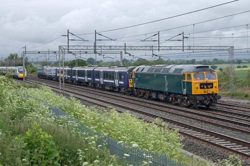 47727, 360105 & 47749, 11.10 Ilford EMUD-Northampton EMD (7Q60, 2L), Gordon`s Lodge 
 In its Caledonian Sleeper livery 47727 'Edinburgh Castle/Caisteal Dhn ideann' brings up the rear of the 11.10 Ilford to Northampton depots move taking 360105 to the Siemens depot at Kingsheath with 47749 'City of Truro' at the front. Notice the member of staff in the rear cab of the Class 47 relaxing in the second man's seat with his feet resting on the control desk! Also, notice the Pendolino heading north on the down fast. This very nearly bowled me completely blocking out the subject as it passed me. Luckily it was travelling extremely slowly allowing me to take an approaching and this going away photographs. 
 Keywords: 47749 360105 47727 11.10 Ilford EMUD-Northampton EMD 7Q60 Gordon`s Lodge GA Greater Anglia Desiro Edinburgh Castle Caisteal Dhn ideann CS Caledonian Sleeper