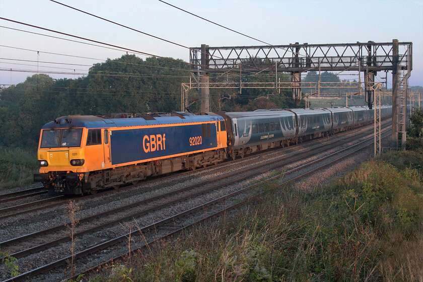 92020, 20.45 Inverness & 19.50 Fort William-London Euston (1M16, 6E), Ashton Road bridge 
 Unlike yesterday morning, see.... https://www.ontheupfast.com/p/21936chg/30018645553/x92010-20-45-inverness-19-50-fort where the train was in shadow today I picked my location with more thought in order to get the up Highland sleeper in the sun! Today also it was being led by 92020 wearing its brighter GBRf livery with the whole thing looking superb in the subtle early morning light. The 1M16 19.590 Fort William/20.45 Inverness to Euston arrived on time (six minutes early in fact!) for the second day on the trot following a run of very disappointing performances. 
 Keywords: 92020 20.45 Inverness 19.50 Fort William-London Euston 1M16 Ashton Road bridge GBRf Caledonian Sleeper