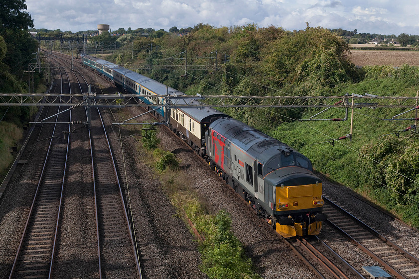 37611 &-037884, return leg of The Greendale Rocket, 13.05 Willesden-Burton-on-Trent (1Z38), Victoria Bridge 
 37611 'Pegasus' brings up the rear of The Greendale Rocket railtour that is returning from Willesden to Burton-on-Trent running as 1Z38. The tour is passing Victoria Bridge just south of Roade with 37 884 at the front. I love the early autumn lighting in this picture from the recently ploughed field to the lineside vegetation just on the turn. 
 Keywords: 37884 return leg of The Greendale Rocket 13.05 Willesden-Burton-on-Trent 1Z38 Victoria Bridge