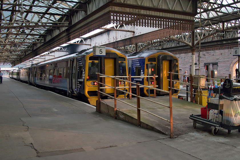 158724, SR 18.43 Edinburgh Waverley-Perth (1L01, 3E) & 158722, stabled, Perth station 
 Two ScotRail 158s stand side-by-side in Perth's south-facing platforms. 158724 has just arrived with the 18.43 from Edinburgh Waverley whilst 158722 was switched off and stabled for the night. Both units were receiving the attention of cleaning crews. Notice the former Motorail ramp in the foreground. A number of Scottish stations had Motorail terminals up until the late 1980s and, in some cases the early 1990s. The car flats would be shunted into this bay, a ramp put across to bridge the gap enabling the cars to be driven off ready for their owners to continue their journeys. 
 Keywords: 158724 18.43 Edinburgh Waverley-Perth 1L01 158722 stabled Perth station