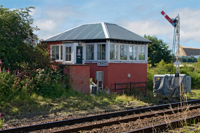 Craigo signal box (Caledonian, 1871) 
 Craigo is a small village between Laurencekirk and Montrose that used to boast a station that was closed 11.06.56. Whilst there are no signs of the station the 1871 Caledonian signal box still stands but is switched out. Of note are the Caledonian latticed signal post that has, unfortunately, lost its final and the vintage gradient post below it. It seems to have been common practice in Scotland to replace the roofs of their boxes with some sort of corrugated material and Craigo is no exception. 
 Keywords: Craigo signal box Caledonian