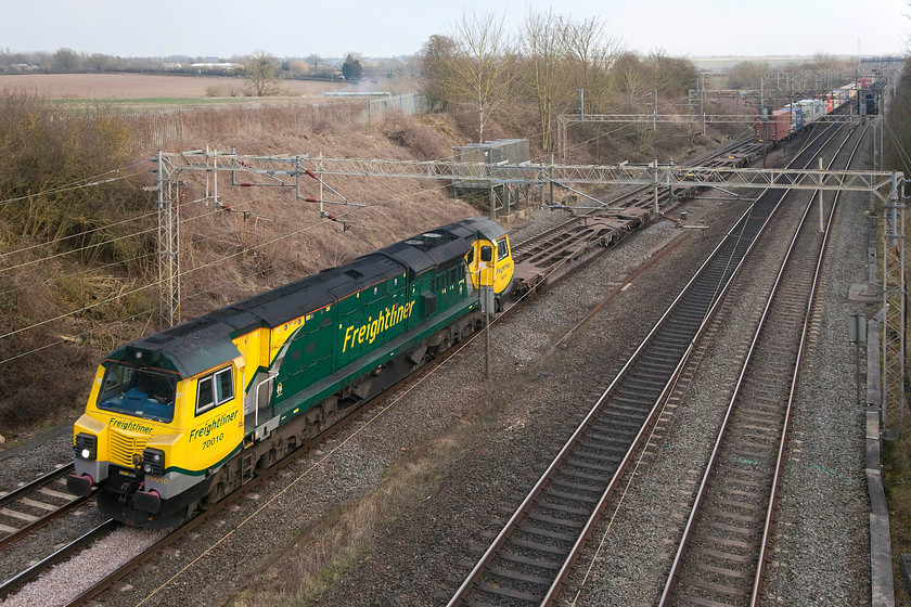 70010, 11.13 Felixstowe N-Trafford Park (4M87), Victoria Bridge 
 As far as I am concerned, the jury is out on the looks of the class 70s. Their transatlantic styling is certainly different to other locomotives we have in the UK but they are not exactly attractive are they, maybe they are the 'brutalists' of the traction world? 70010 is seen leading a not very heavily loaded 11.13 from Felixstowe to Trafford Park Freightliner past Victoria Bridge on the WCML between Milton Keynes and Northampton. 
 Keywords: 70010 11.13 Felixstowe N-Trafford Park 4M87 Victoria Bridge