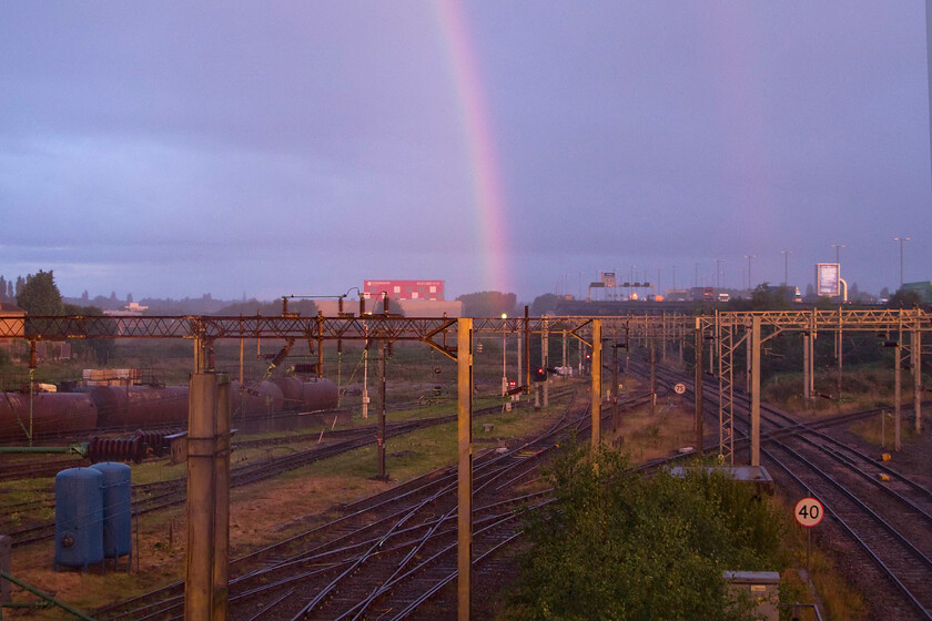 Rainbow & sunrise over Bescot Yard, Bescot Stadium station footbridge 
 The rain was absolutely coming down when we arrived at Bescot Stadium station but amazingly the rising sun managed to find a hole in the cloud and crated this double rainbow scene looking north from the station footbridge. Notice the traffic on the elevated section of the M6 motorway in the background. 
 Keywords: Rainbow & sunrise over Bescot Yard, Bescot Stadium station footbridge