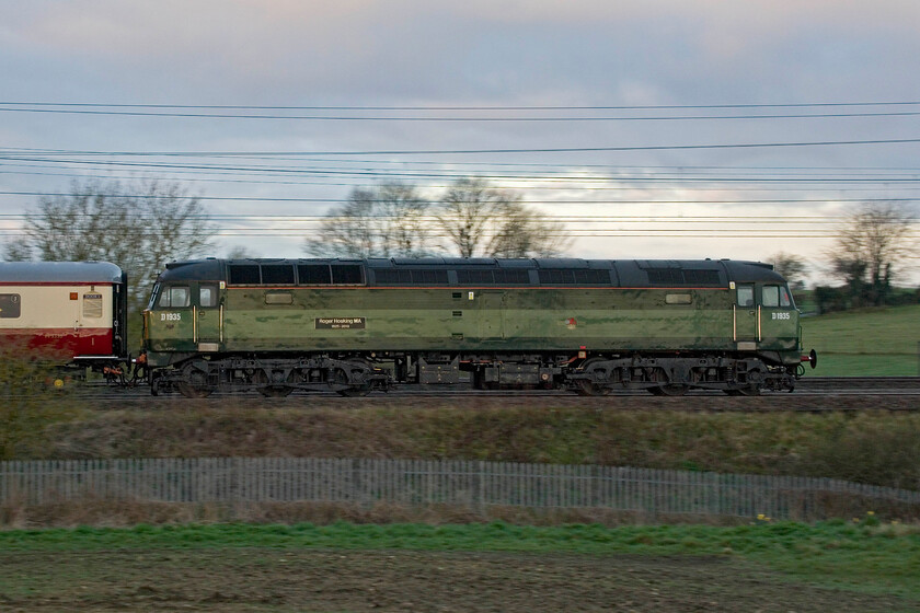 D1935, outward leg of The Cotswold Explorer, 06.30 Northampton-Worcester Shrub Hill (1Z46, 40L), between Roade & Ashton 
 D1935 'Roger Hoskins MA 1925-2013' (previously numbered 47257, 47650 & 47805) brings up the rear of The Cotswold Explorer charter as it passes the fields in the half-light of a March morning between the villages of Roade and Ashton. The Class 47 was towed all the way to Worcester and back, initially by D213 'Andania' but from West London and back by 46100 'Royal Scot'. 
 Keywords: D1935 The Cotswold Explorer 06.30 Northampton-Worcester Shrub Hill 1Z46 between Roade & Ashton Roger Hoskins MA 1925 - 2013