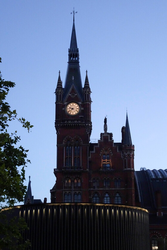 Clock tower, London St. Pancras station 
 According to the clock of St. Pancras, it is 21.39. The station and tower need no introduction being designed by George Gilbert Scott, the great proponent of the style known as the Gothic Revival, a Victorian style with echoes back to the Gothic era of the Middle Ages. The floor immediately below the clock where the tall windows are seen is an incredible apartment that has been featured in a TikTok video, see..... https://www.tiktok.com/@jublondon/video/7290584900825107744?embed_source=121374463%2C121442748%2C121439635%2C121433650%2C121404358%2C121351166%2C121331973%2C120811592%2C120810756%3Bnull%3Bembed_blank&refer=embed&referer_url=www.stpancrasclocktower.london%2Fabout-us&referer_video_id=7290584900825107744 
 Keywords: Clock tower London St. Pancras station