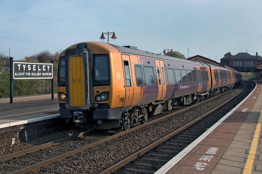 172345 & 172214, LN 11.46 Dorridge-Great Malvern (2V24, 1E), Tyseley station 
 172345 and 172214 have just paused at Tyseley station and are getting underway again with the 11.46 Dorridge to Great Malvern train. The train is just passing a reproduction GWR style running-in sign that is just one feature of the this nicely preserved station. 
 Keywords: 172345 172214 11.46 Dorridge-Great Malvern 2V24 Tyseley station