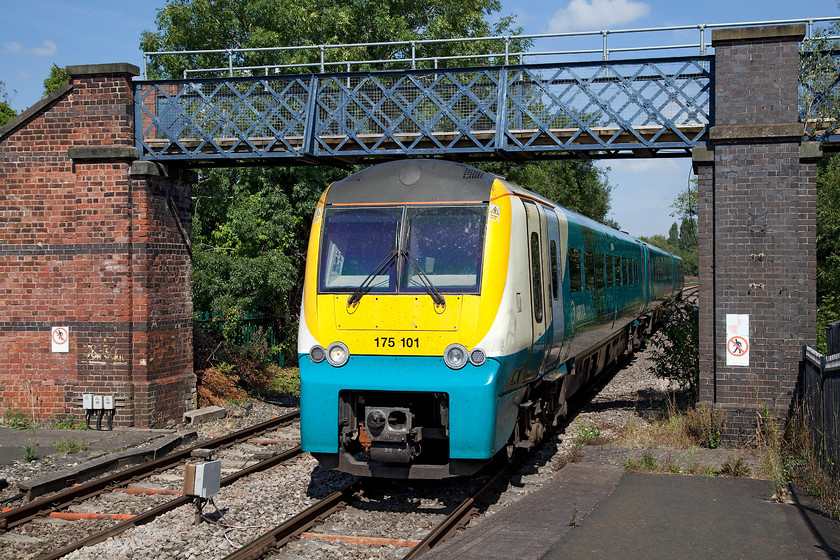 175101, AW 09.30 Manchester Piccadilly-Milford Haven (1V38), Leominster station 
 170101 arrives at Leominster station working the 09.30 Manchester Piccadilly to Milford Haven service. The unusual footbridge that the train is passing under carries the circular long-distance footpath, the Herefordshire Trail over the railway. 
 Keywords: 175101 09.30 Manchester Piccadilly-Milford Haven 1V38 Leominster station